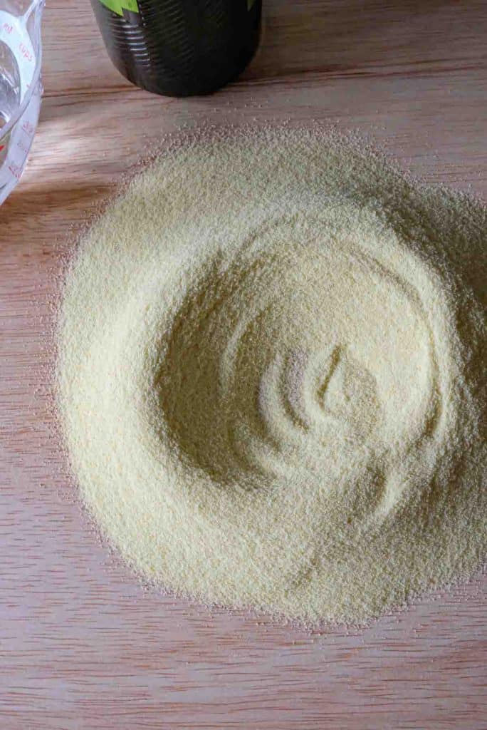 A small mound of semolina flour with a circular indent in the middle for pouring the water and olive oil.