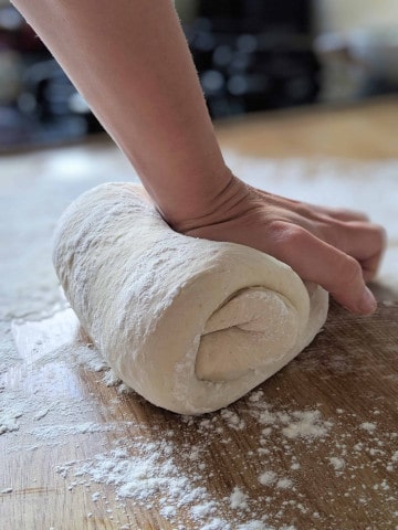 hand kneading dough until smooth