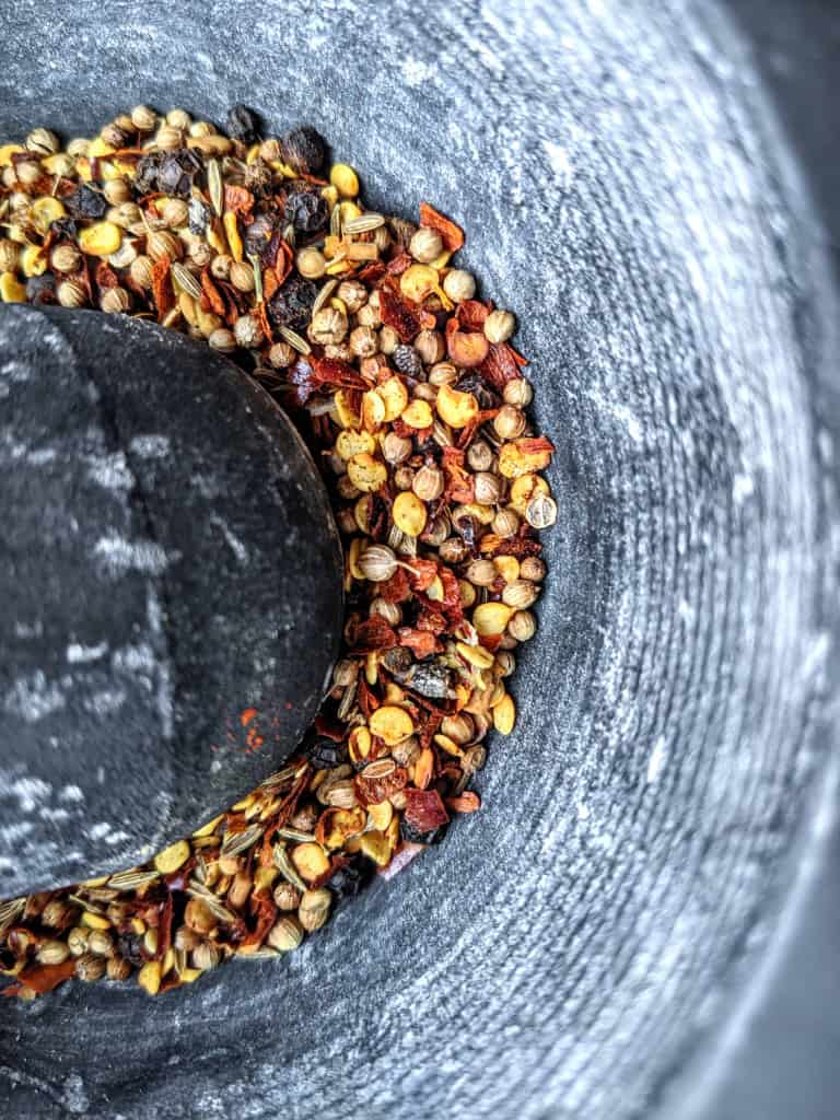 grinding spices for homemade Ethiopian berbere