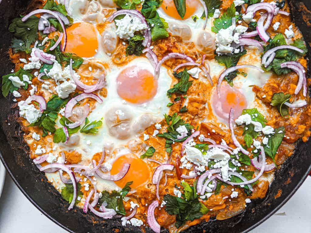 sweet potato shakshuka with parsley, cilantro, feta, and red onion