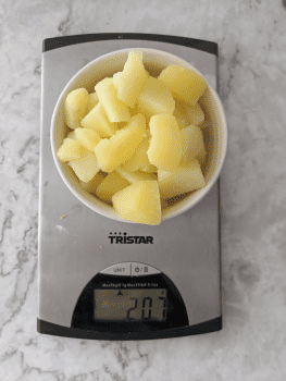 Weighing potatoes after boiling for a homemade gnocchi recipe.