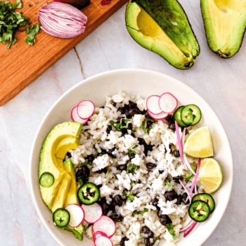 This coconut lime rice with cilantro and black beans is the perfect summer side dish that’s ready in 15 minutes with only 5 minutes of prep. Make it a meal with a few yummy additions like jalapenos, radishes, and avocado.