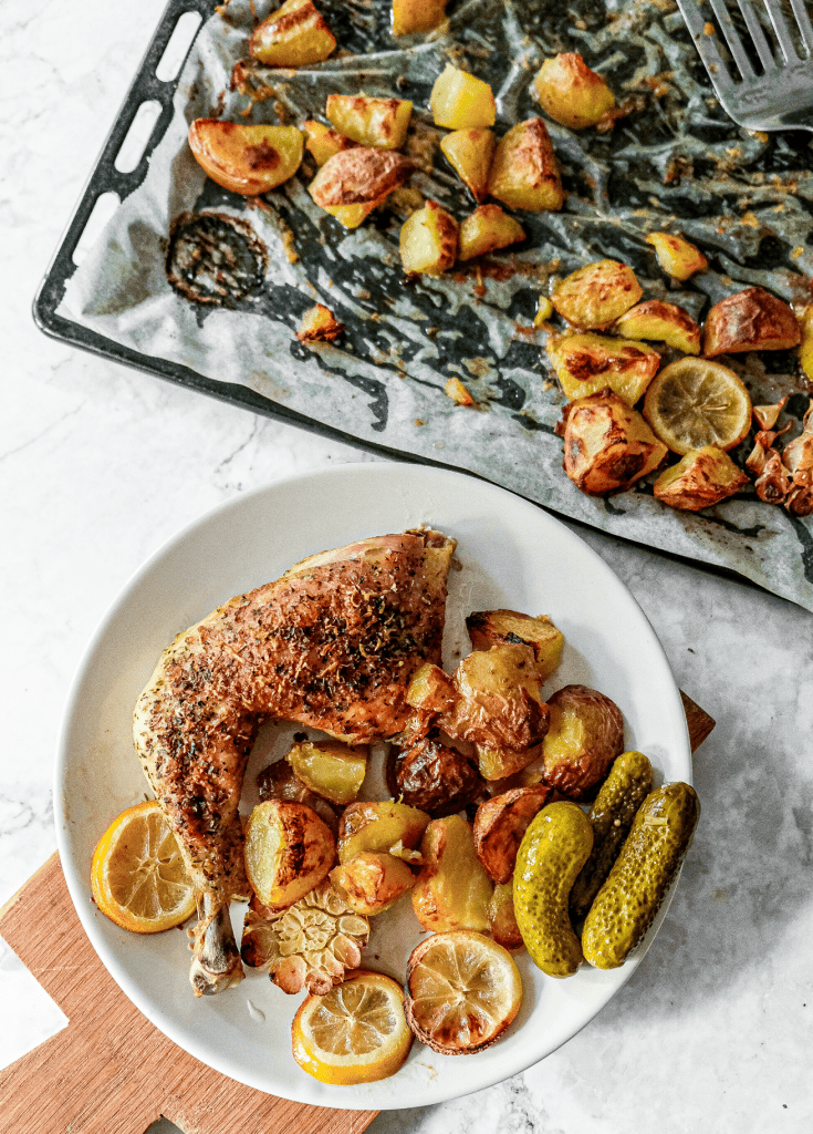 Crispy sheet pan parmesan chicken thighs and potatoes with garlic, lemon and herbs