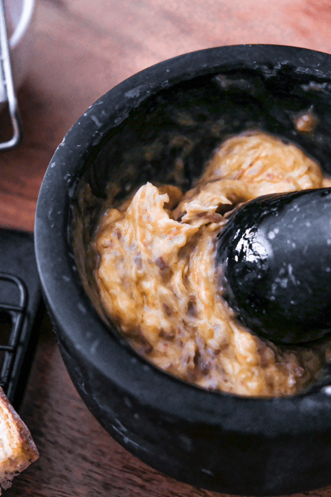 Preparing anchovy butter for crostini.