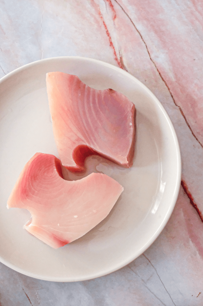 Perfect pink tuna steaks before searing and serving with coconut curry sauce.