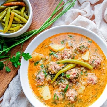 This classic Romanian soup features hearty porcupine meatballs swimming in a creamy and flavourful broth dotted with diced veggies and fresh herbs like lovage, parsley and dill. Serve with hot pickled peppers and crusty bread for a perfect cold weather meal.