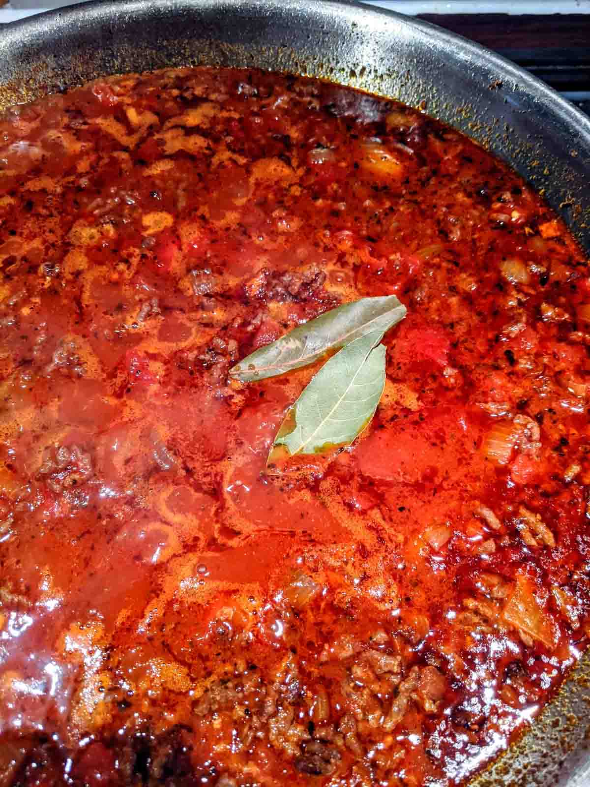 Cooking the meat sauce for the Ethiopian lasagna in a stainless steel skillet.