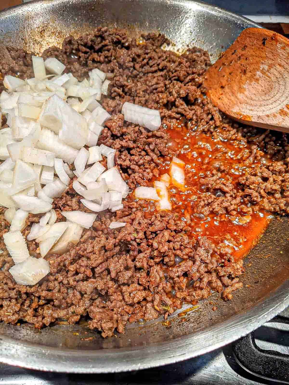 The ground beef and onion being mixed for the Ethiopian berbere pasta sauce.