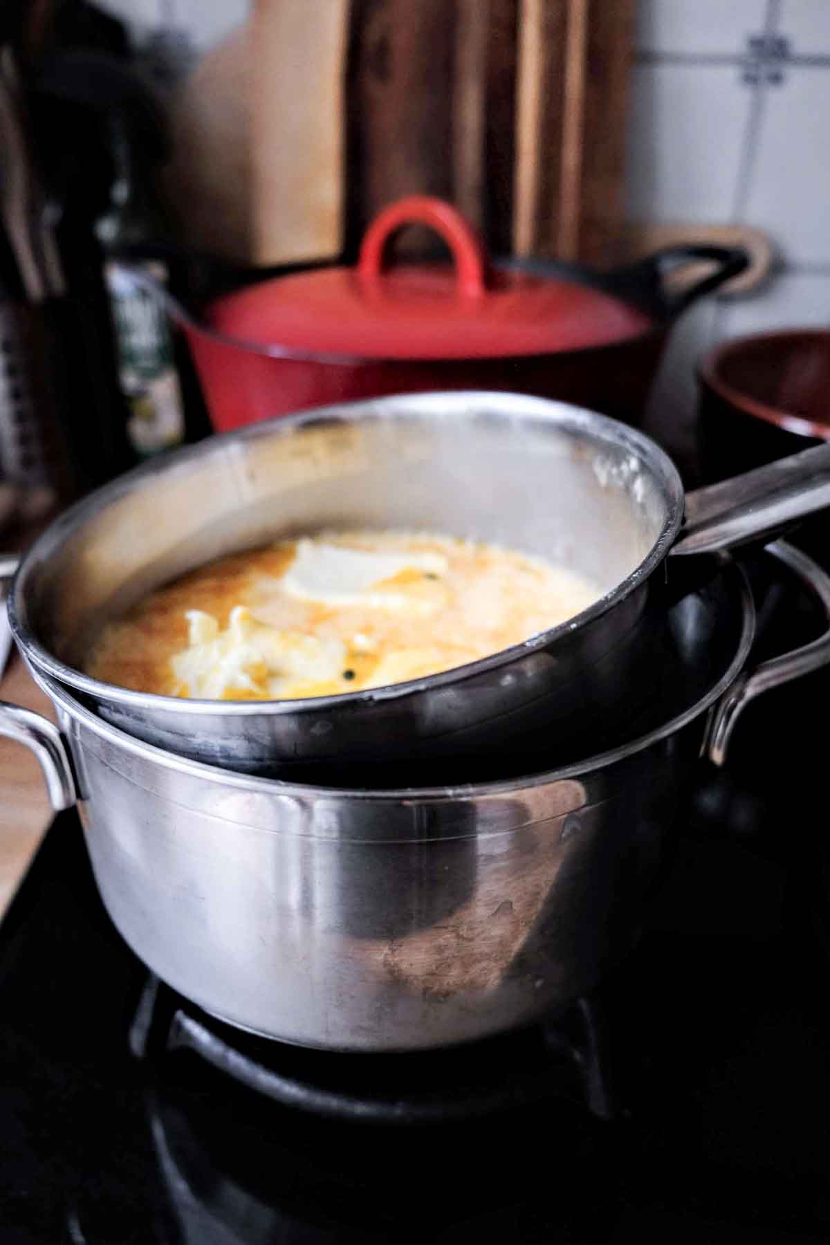 Cooking egg and passionfruit juice together in a double boiler to make curd. 