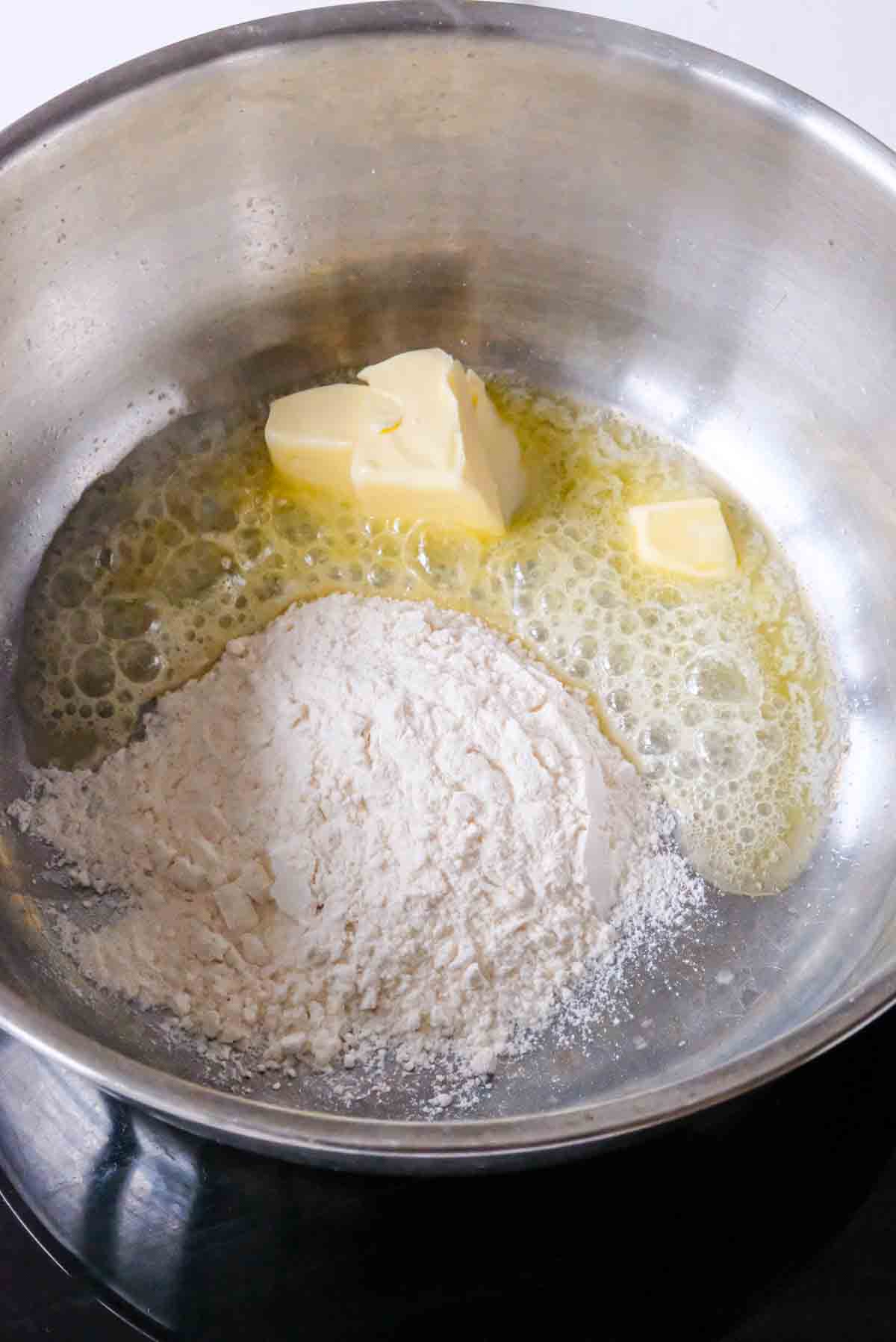 Melting butter and flour in a saucepan to make bechamel sauce.