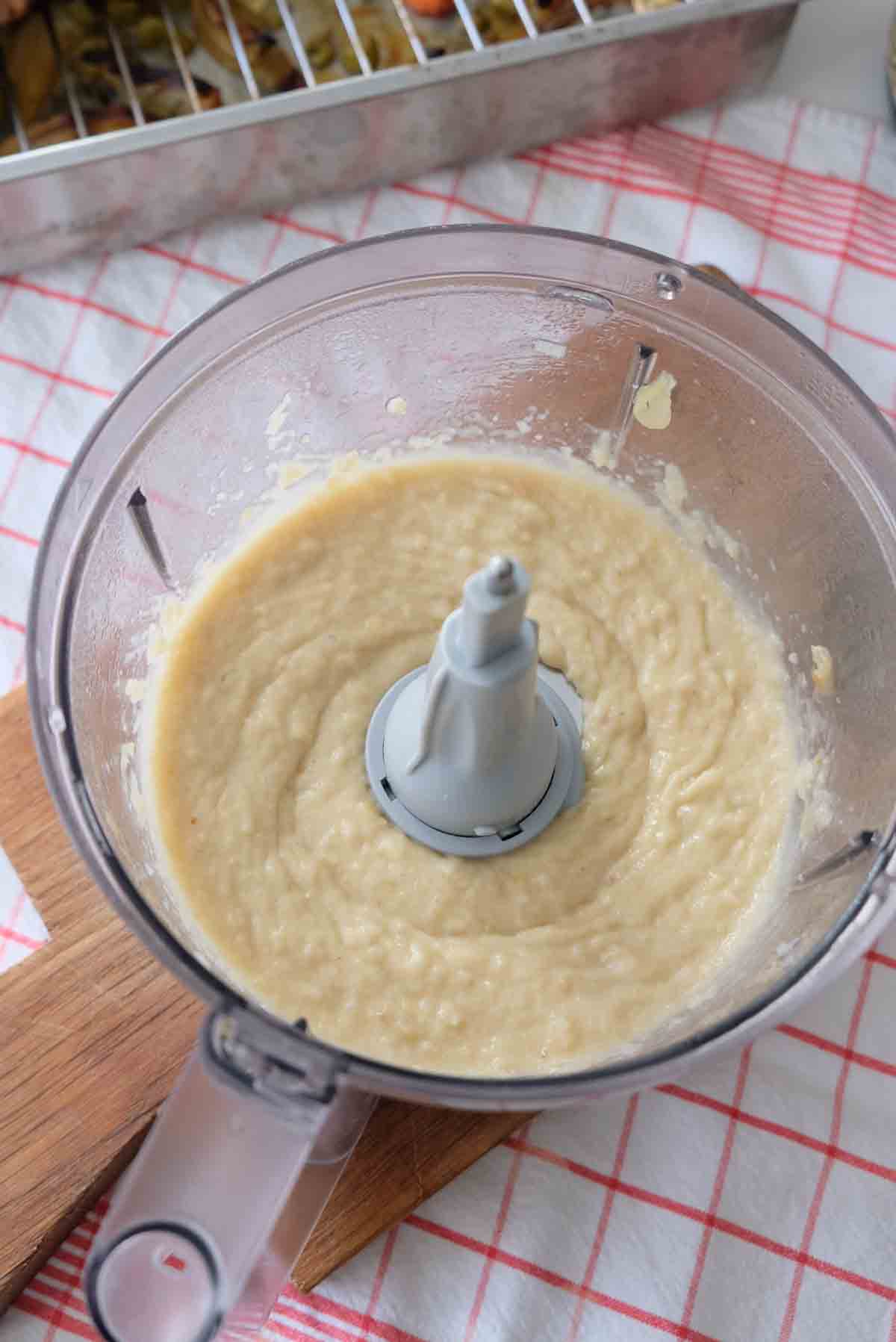 Smoothly blended sauce in a food processor bowl.