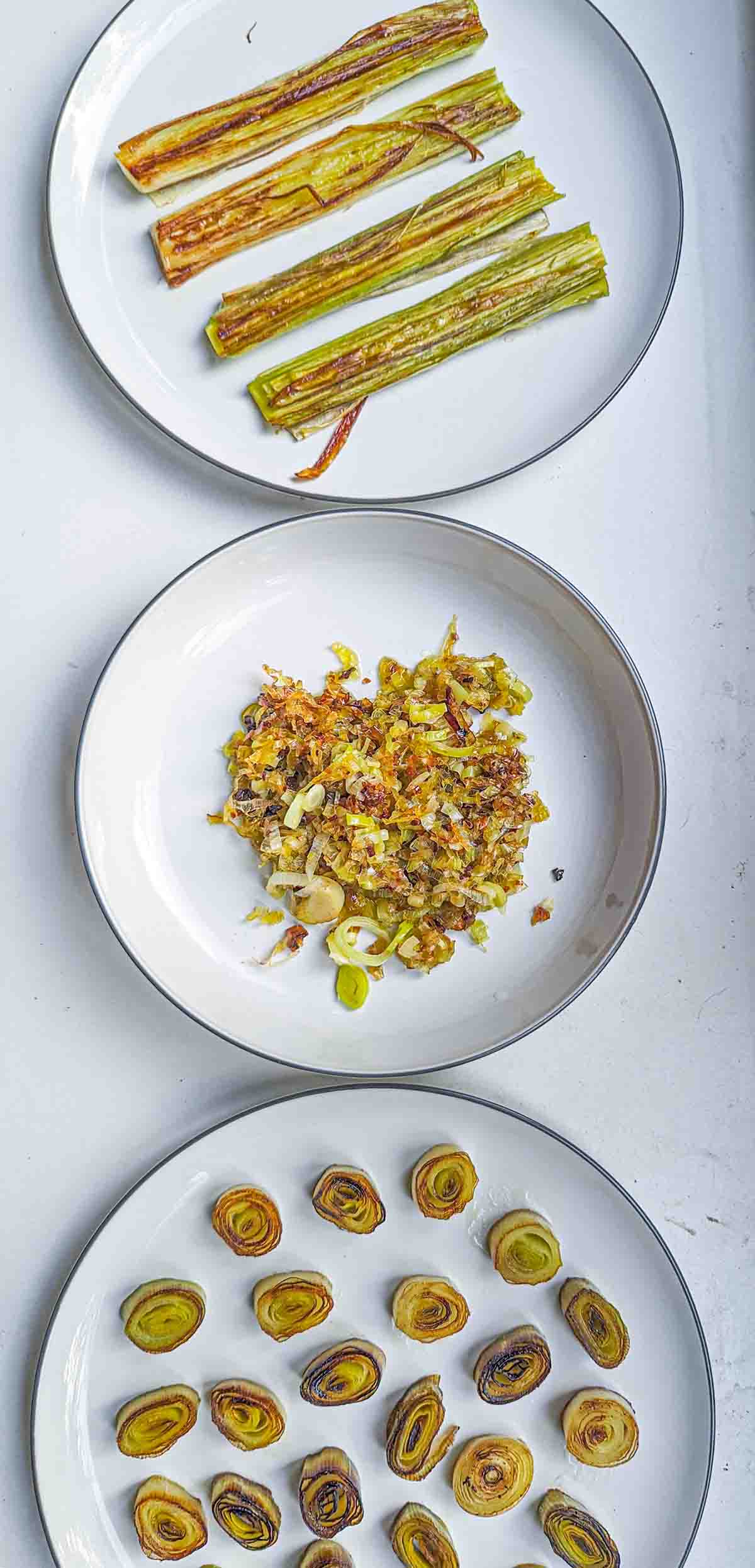 an overhead shot of three plates of caramelized leeks prepared differently