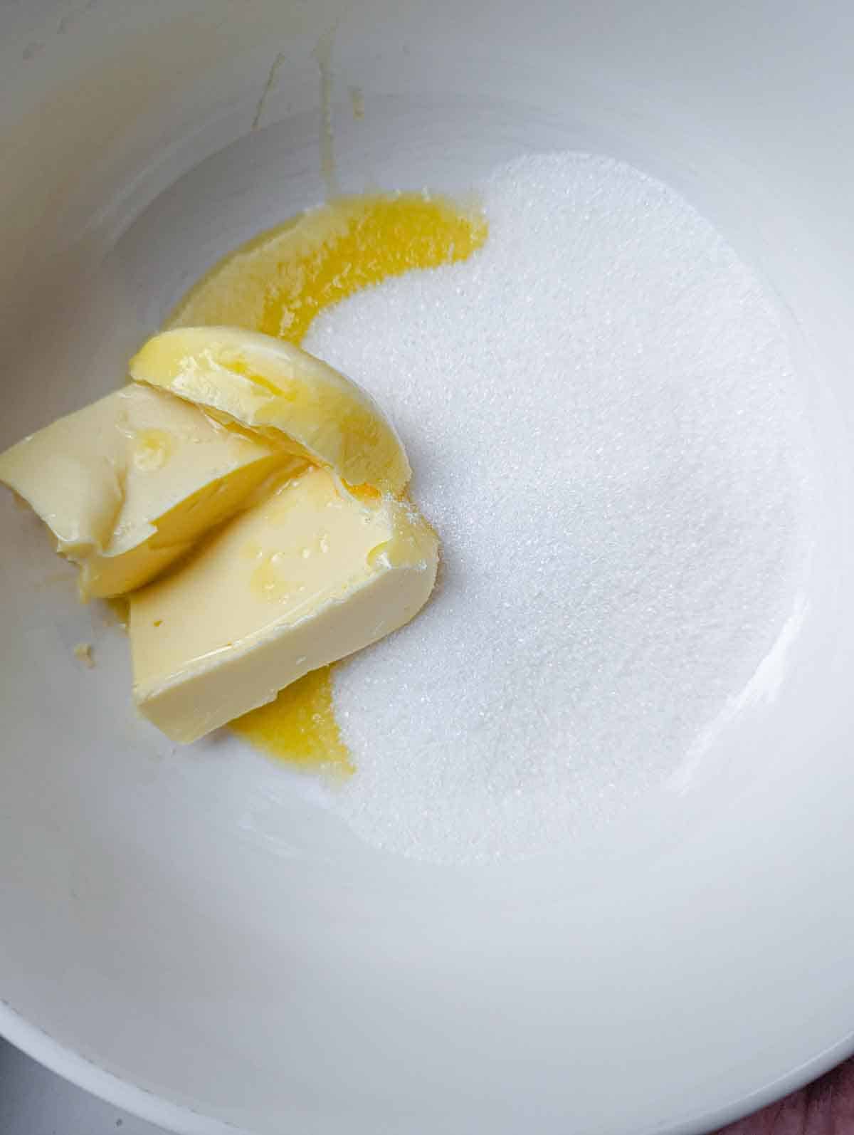 Softened butter and sugar in a bowl.