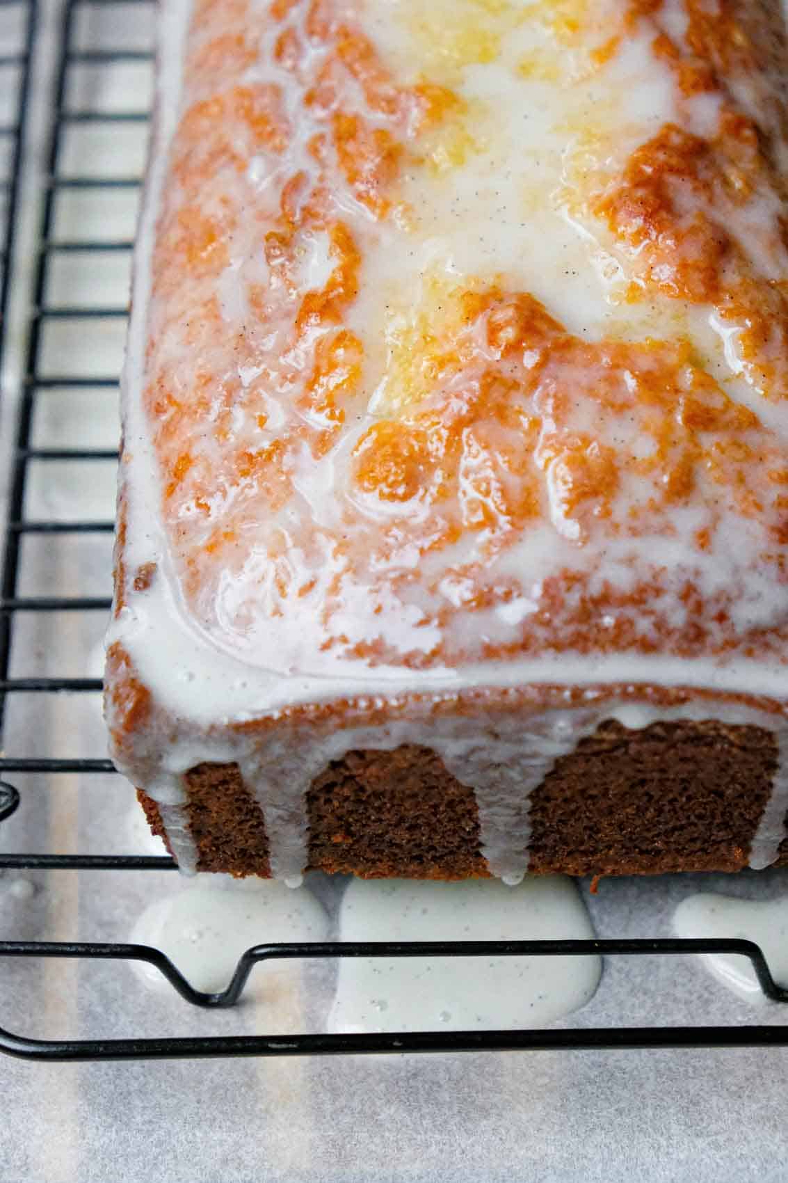 Just glazed vanilla cake on a wire rack.