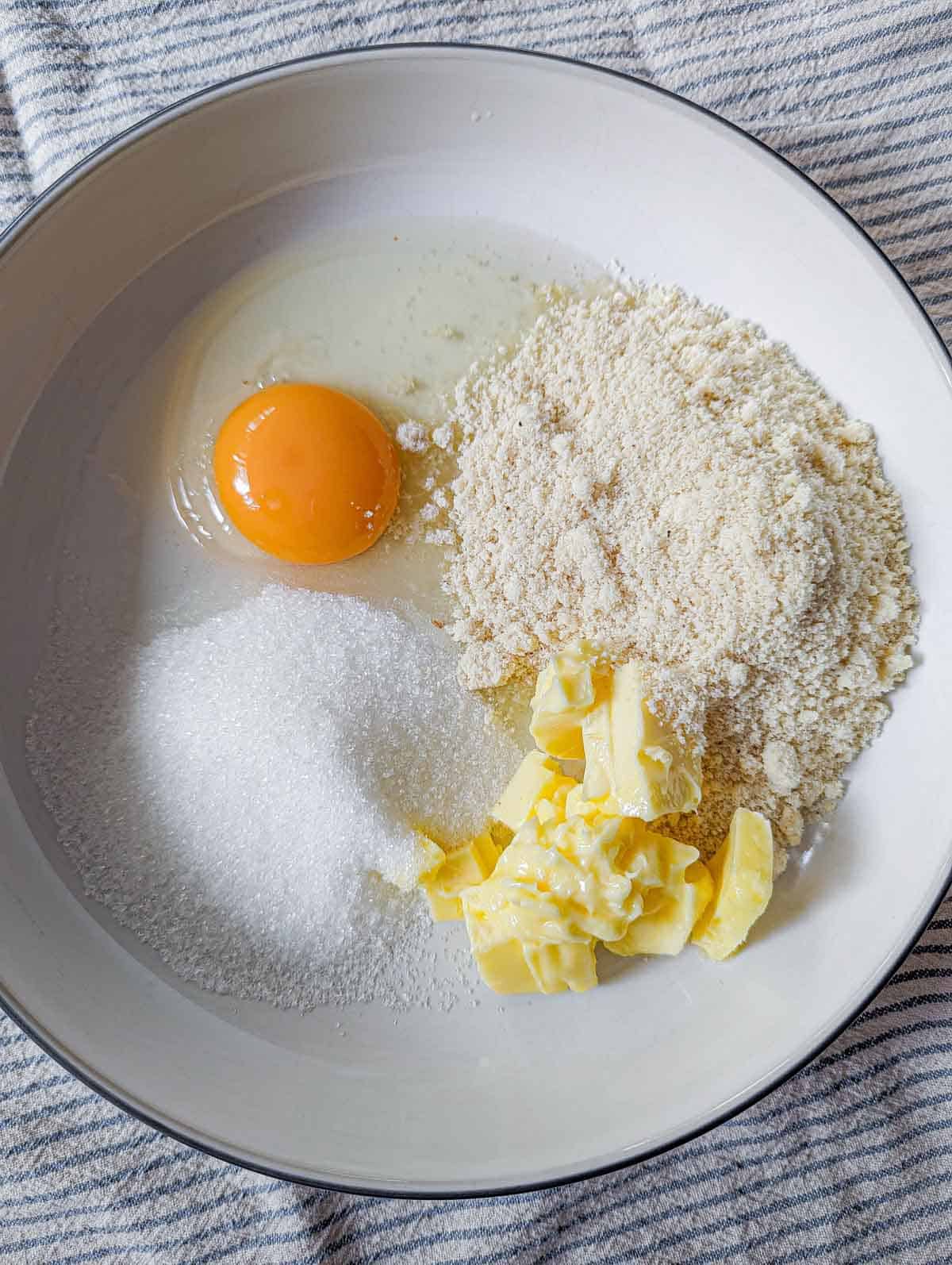 Mixing almond meal, egg, sugar and butter for almond cream.