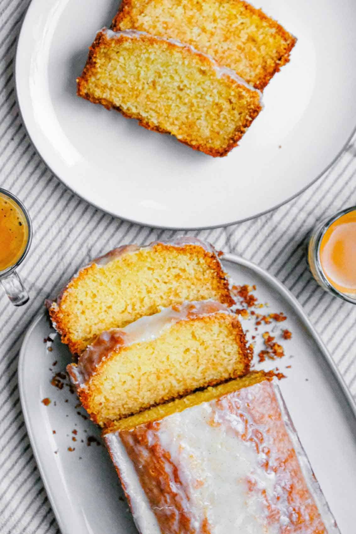 Vanilla loaf cake sliced and plated to be served with coffee.