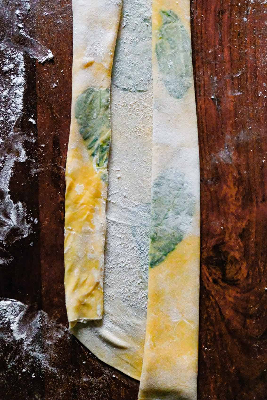 Basil leaves pressed into pasta