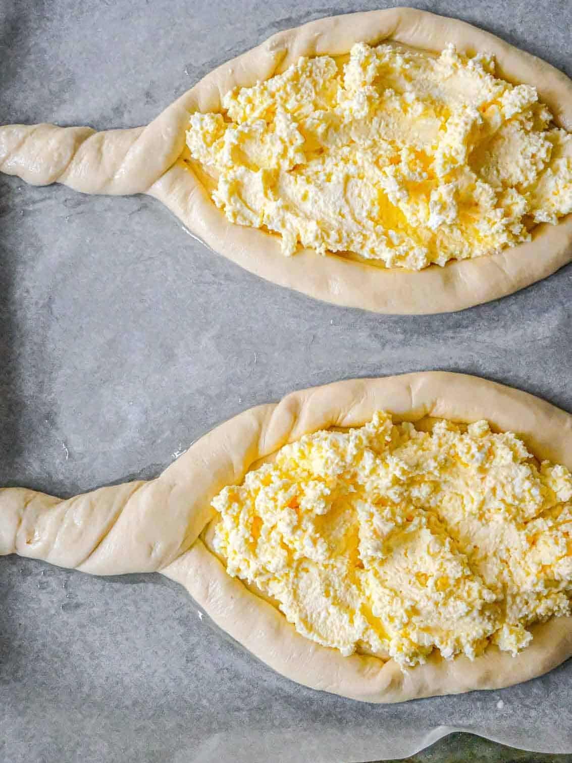 cheese filling inside uncooked dough khachapuri shapes