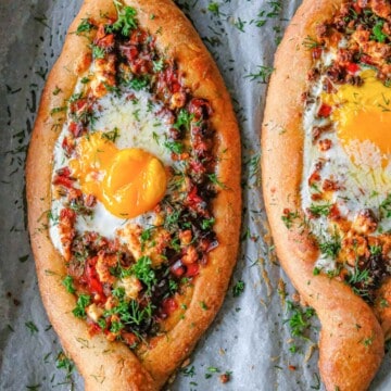 close up of shakshuka bread with eggs and melted butter