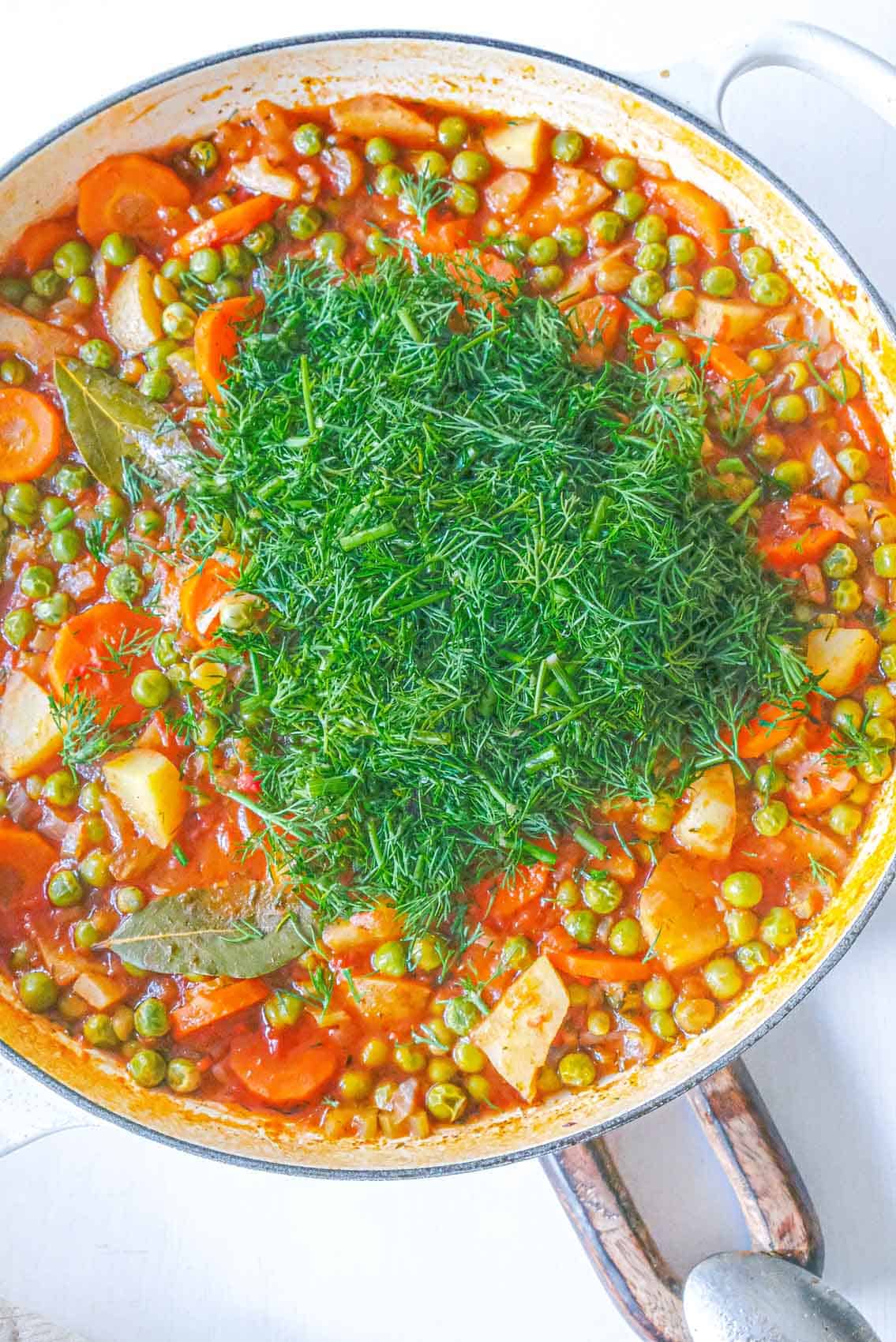 Fresh dill added to Romanian green pea stew.