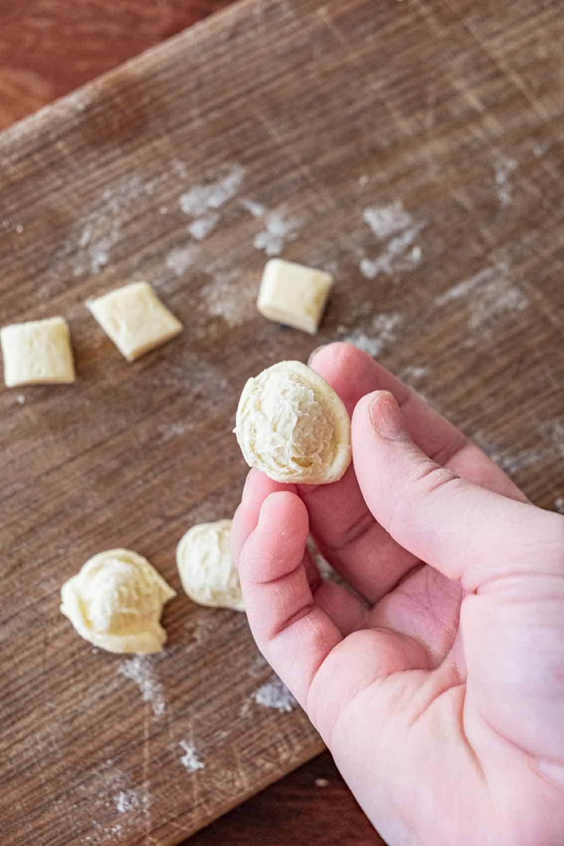 Flipping a pressed piece of dough inside out to make orechiette.