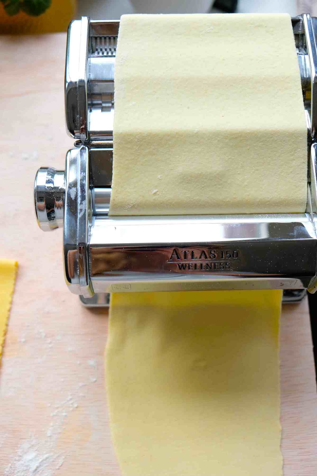 Pasta dough being rolled out using a Marcato Atlas pasta machine.