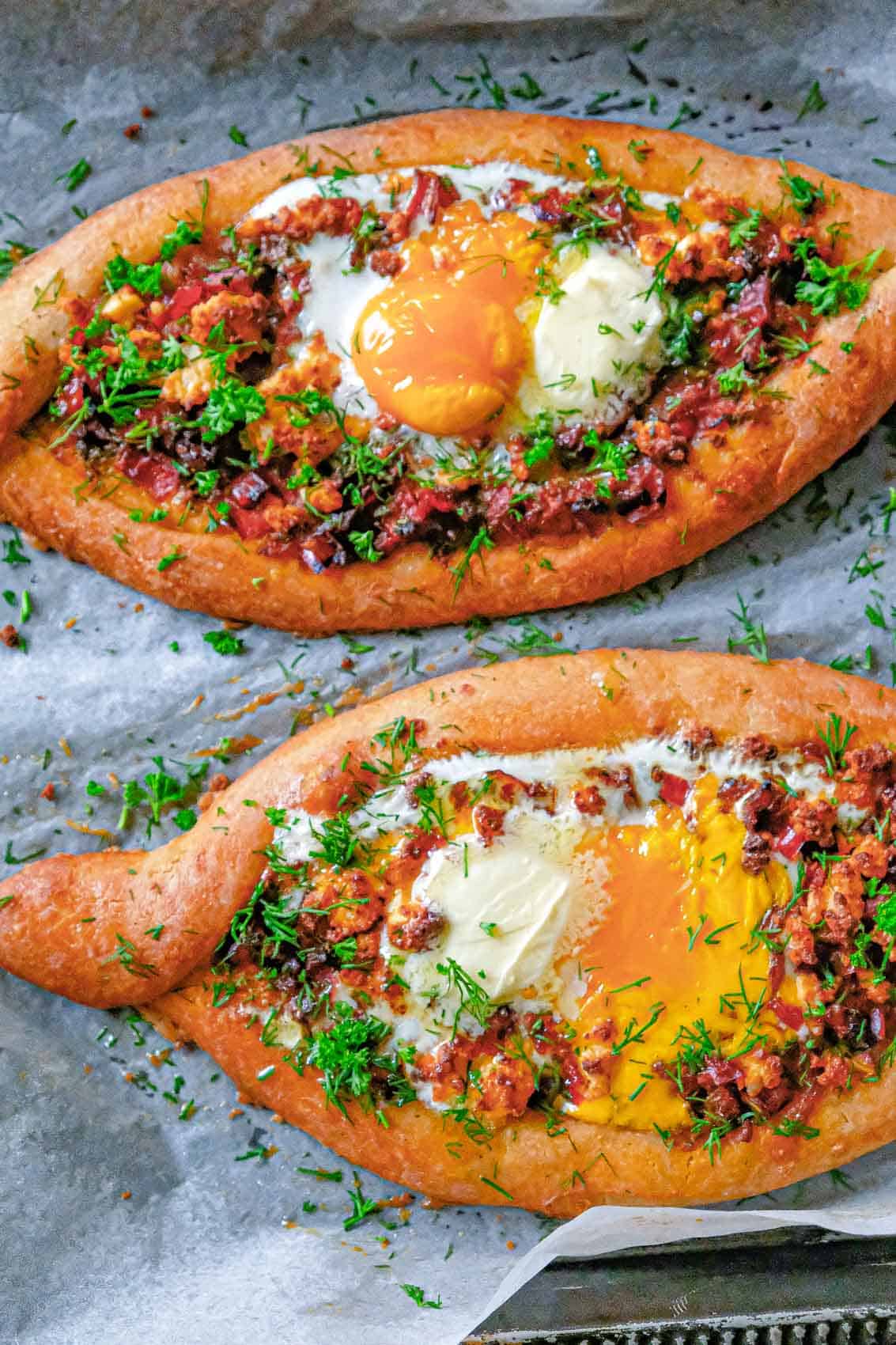 close up of shakshuka bread with eggs and melted butter