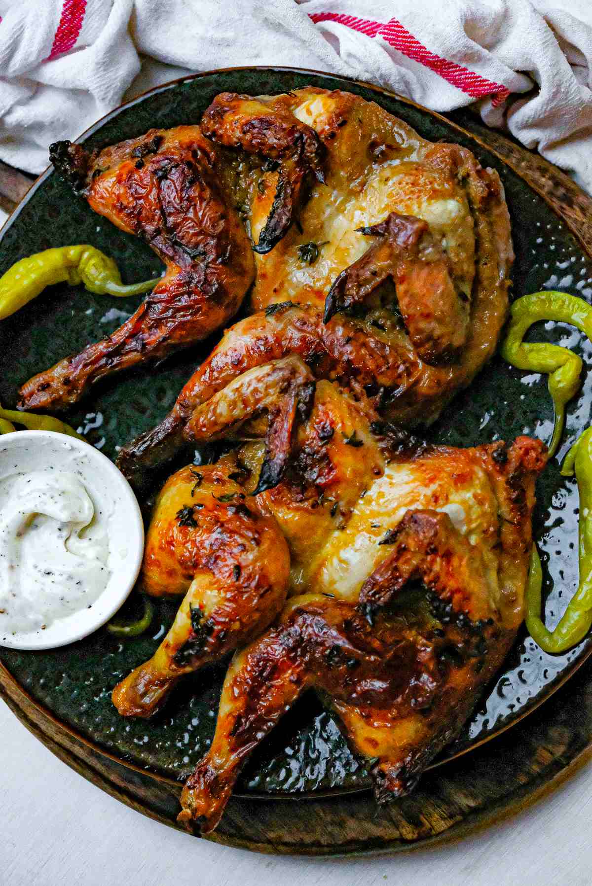 Two spatchcock roast poussin with pickled chilis and garlic aioli