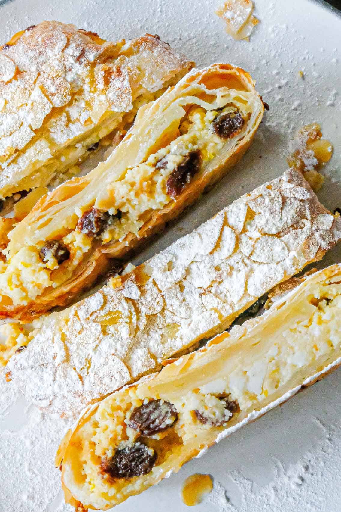 a look at the inside of the sliced strudel showing the cheese filling