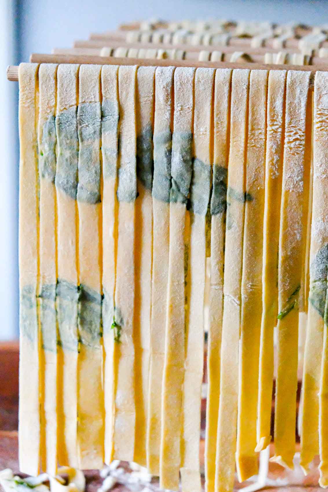 laminated tagliatelle with basil leaves in the pasta dough