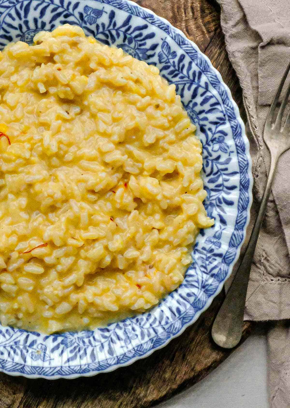 Close up of risotto Milanese on a plate.