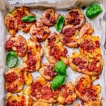 close up red pesto potatoes with basil