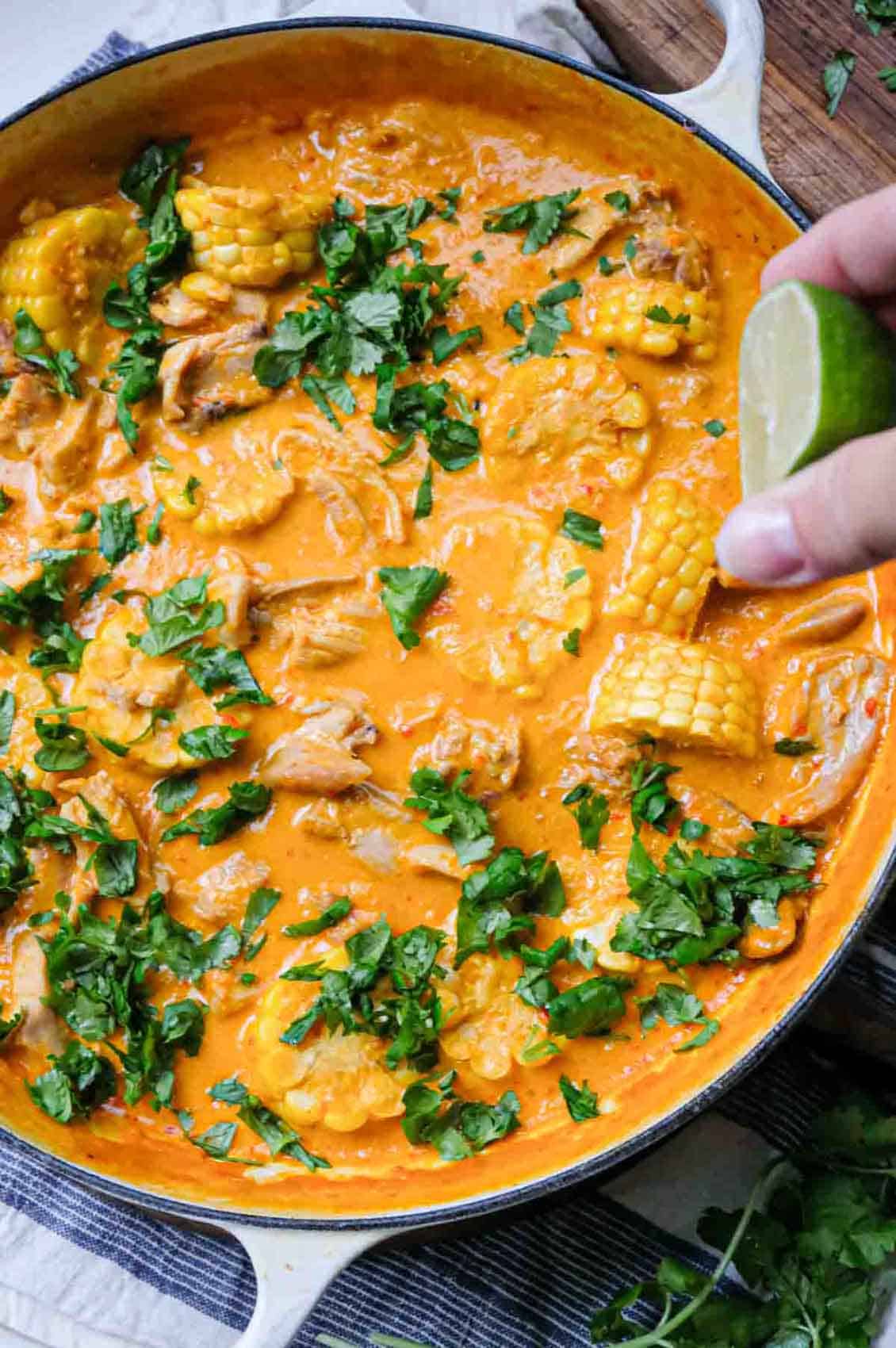 finishing coconut chicken curry with lime