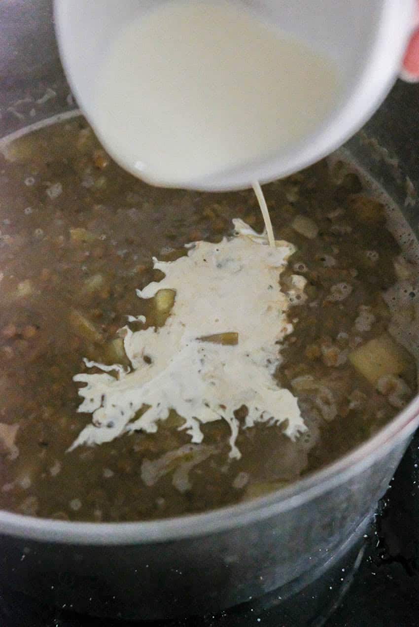 adding cream to lentil soup