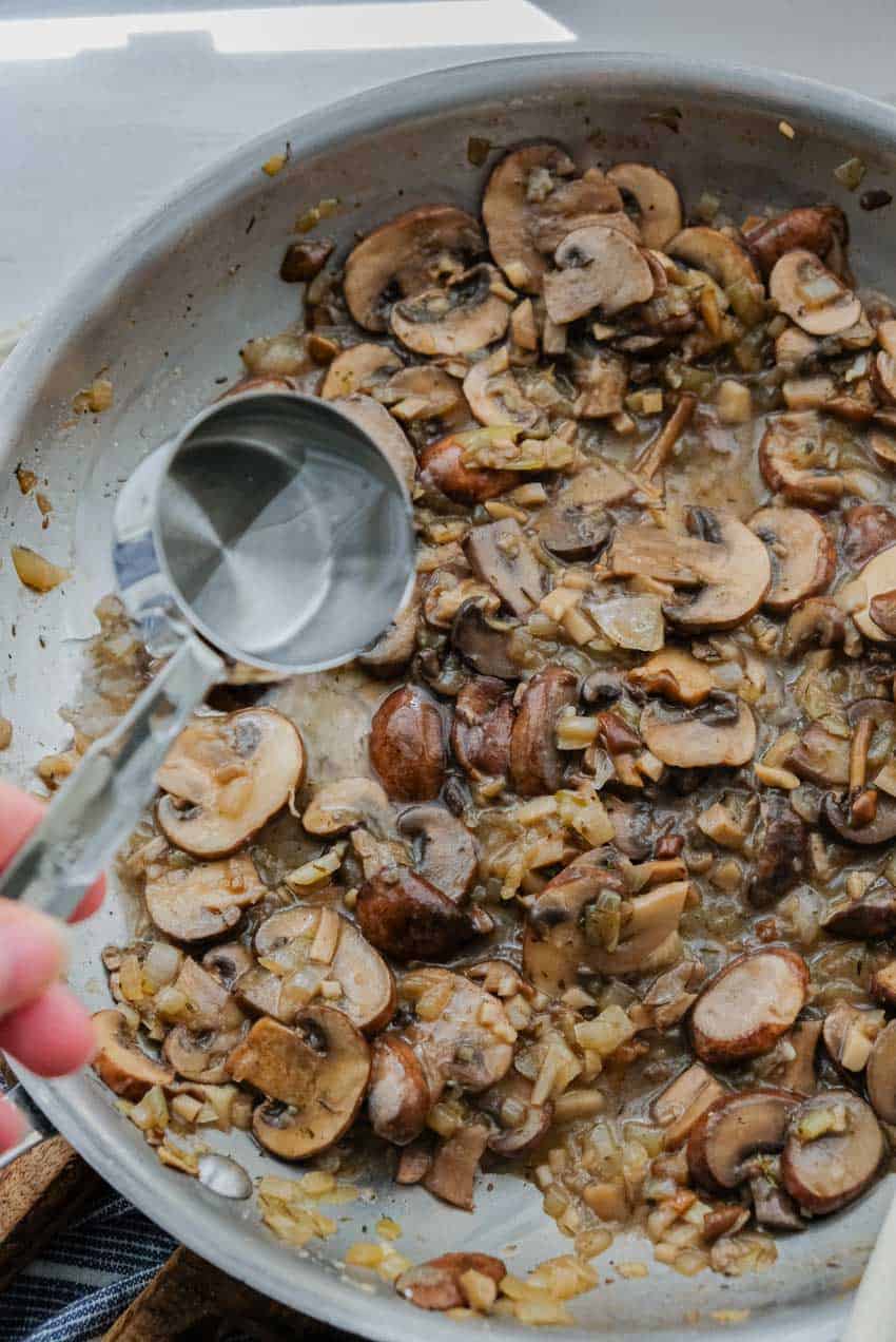 adding water to mushroom stew