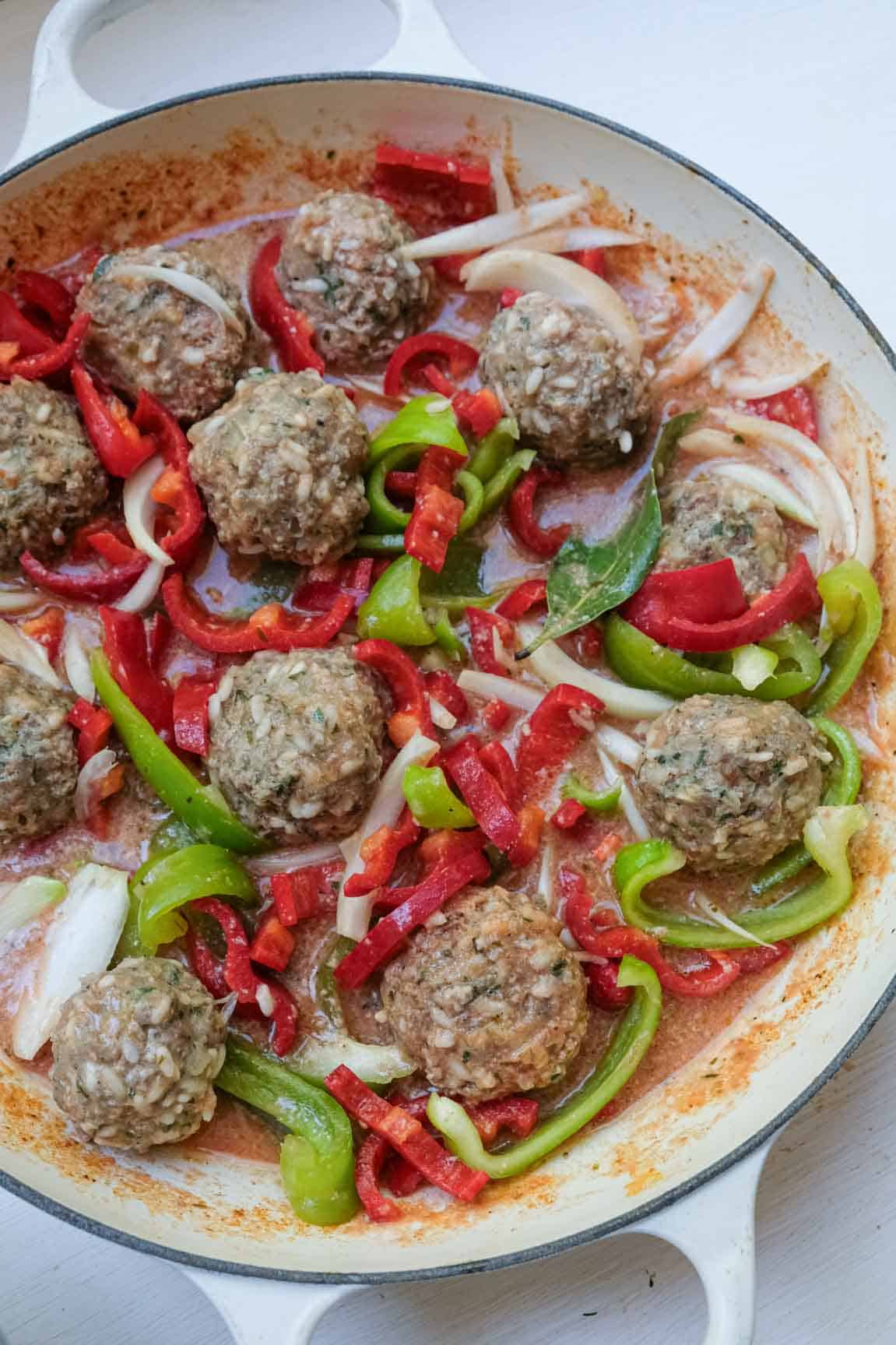 peppers and onions added to stewed meatballs