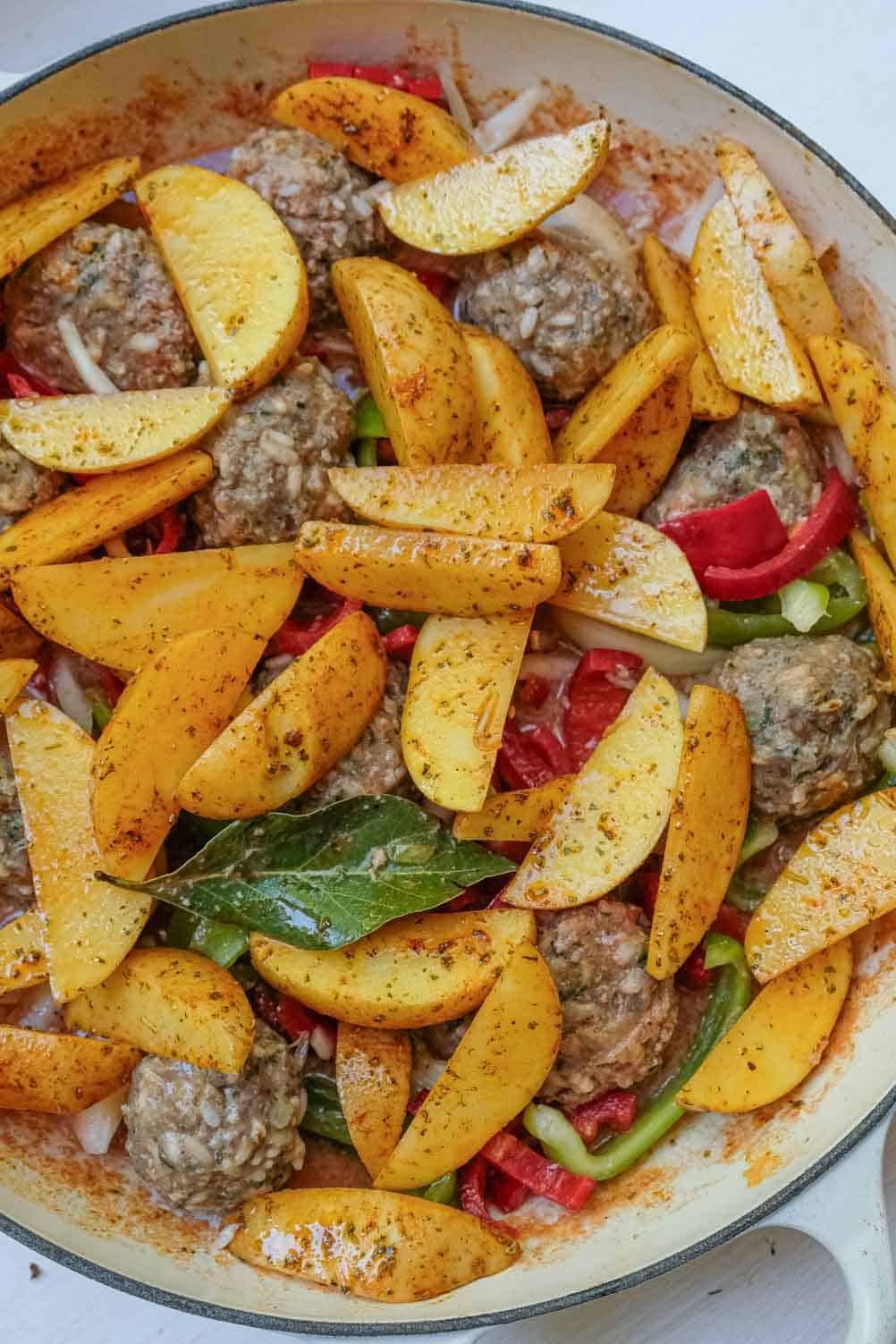 potatoes over rice meatballs in pan
