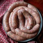 homemade romanian sausages arranged on a plate