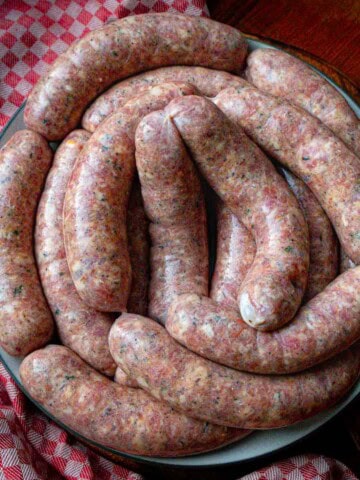 homemade romanian sausages arranged on a plate