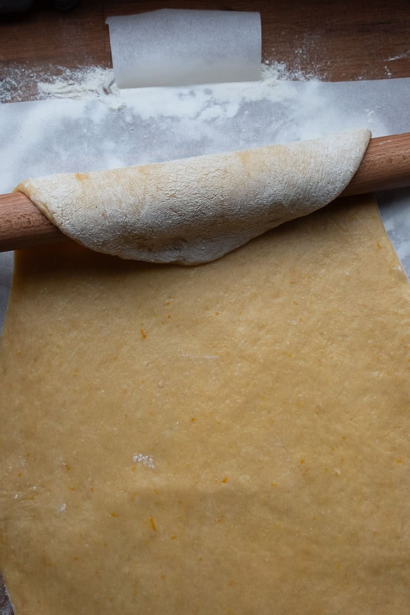 laying no knead dough on paper