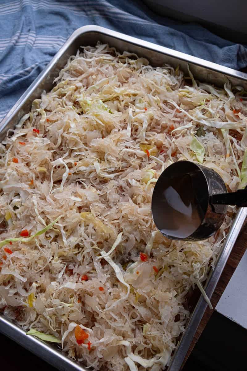 pouring liquid over varza