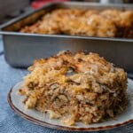 a plate of ground meat and rice topped with shredded sauerkraut