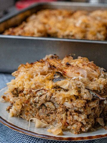 a plate of ground meat and rice topped with shredded sauerkraut