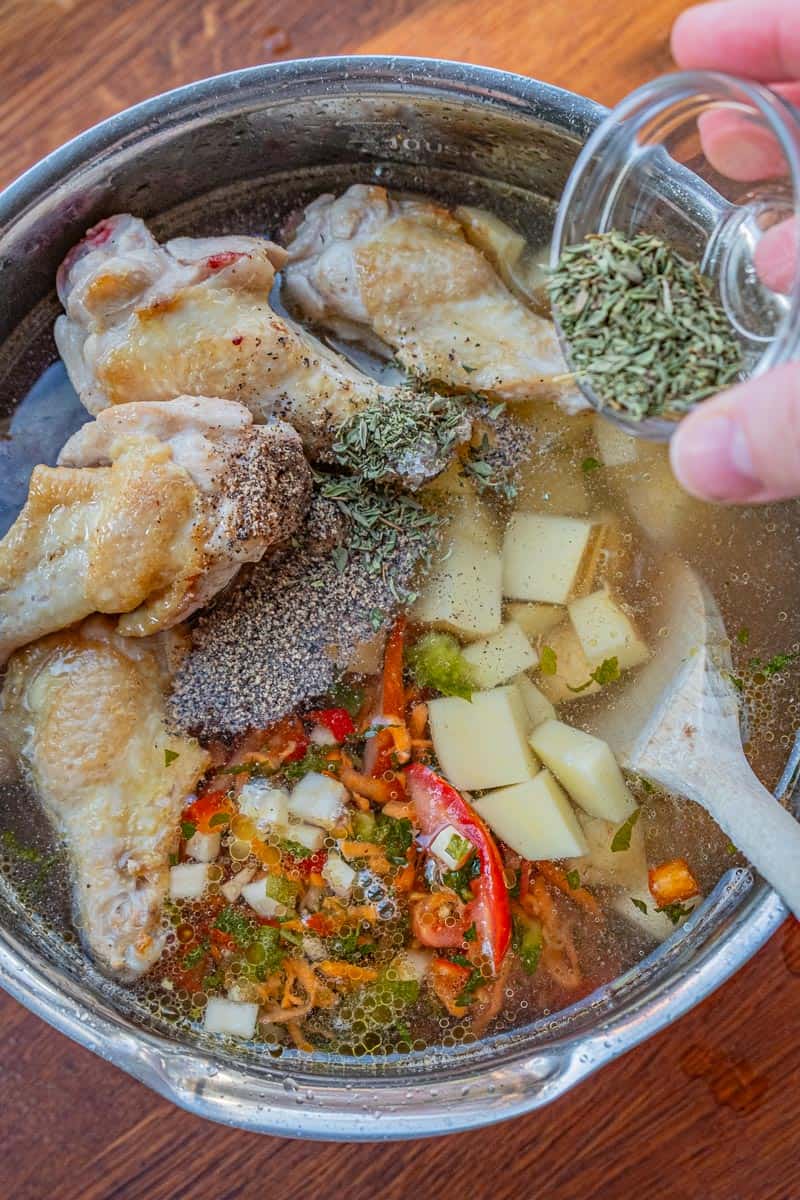 adding seasoning to soup