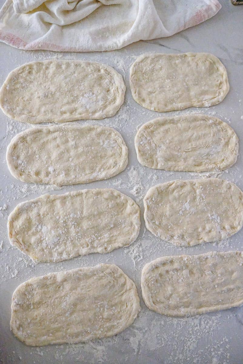 dough shaped into pita buns
