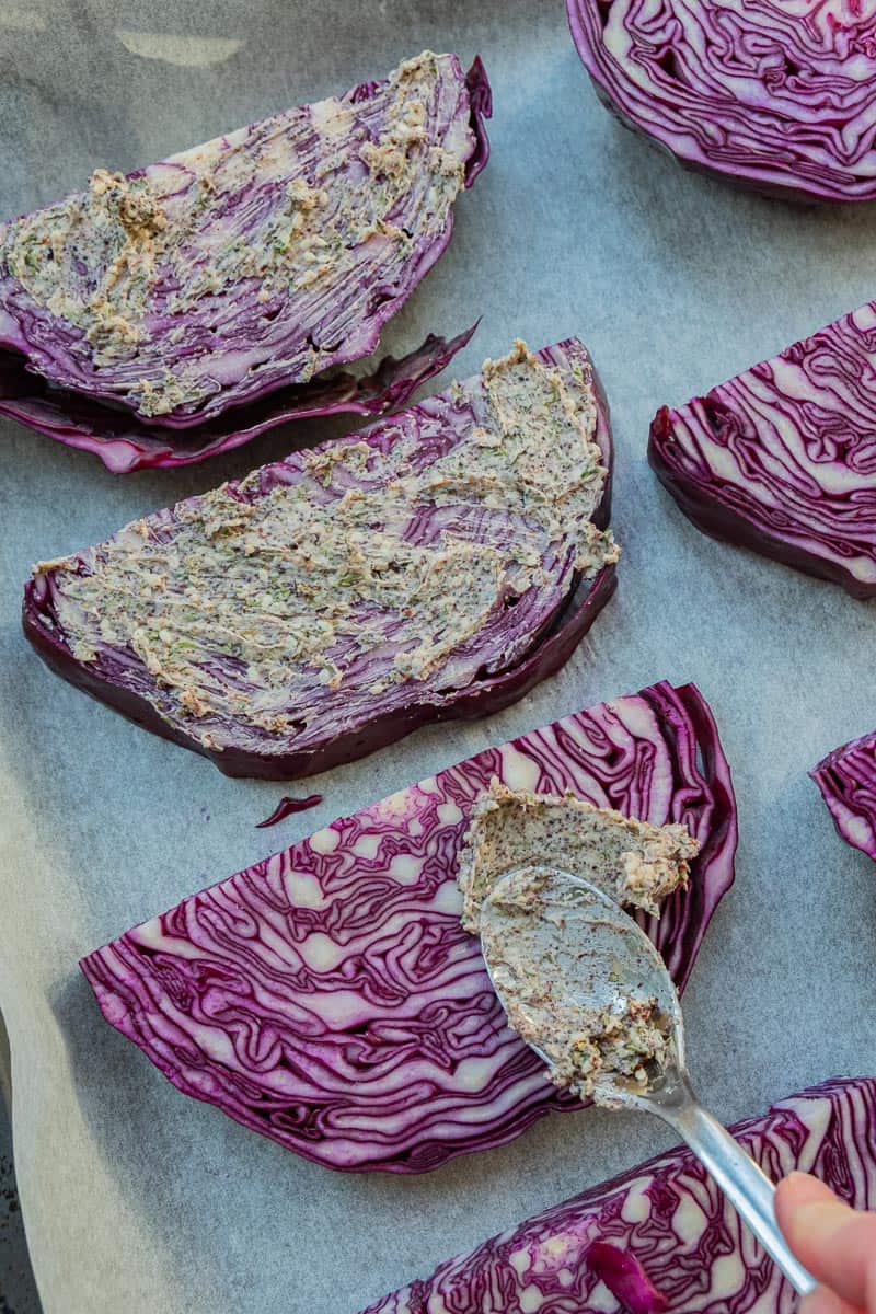 smearing butter on cabbage