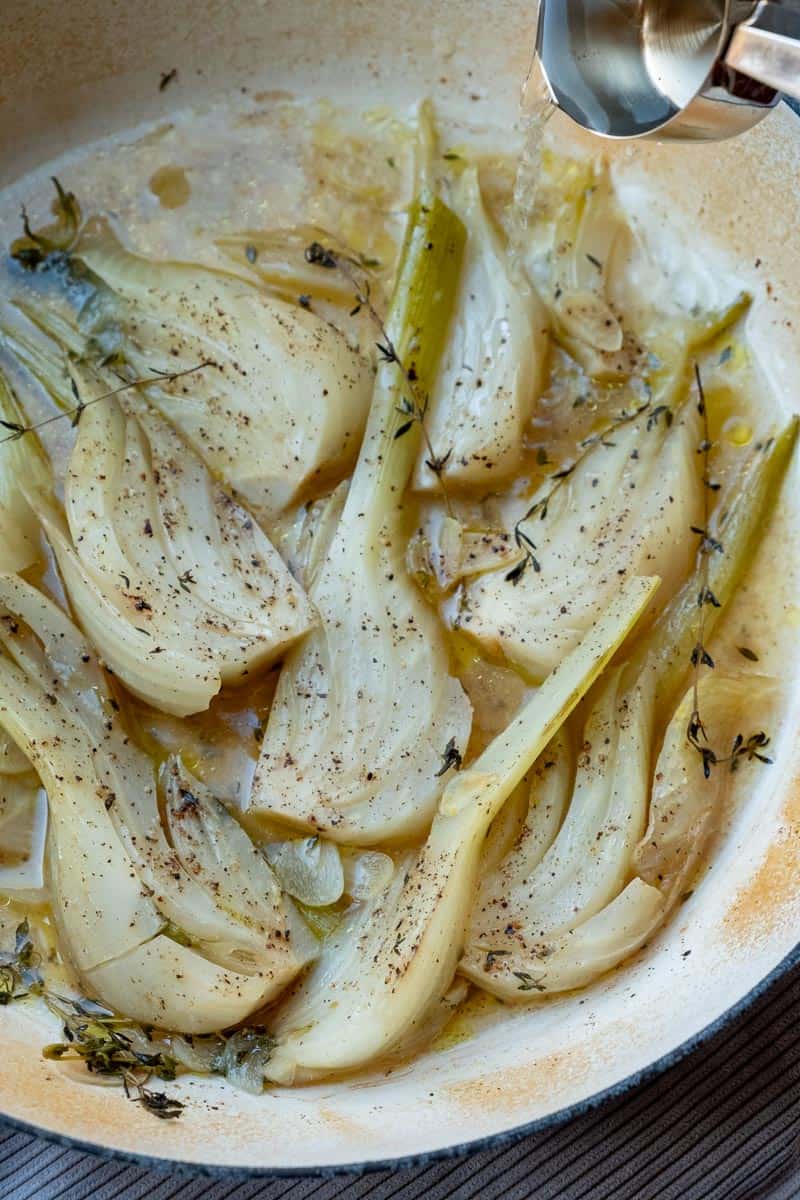 pouring in braising liquid